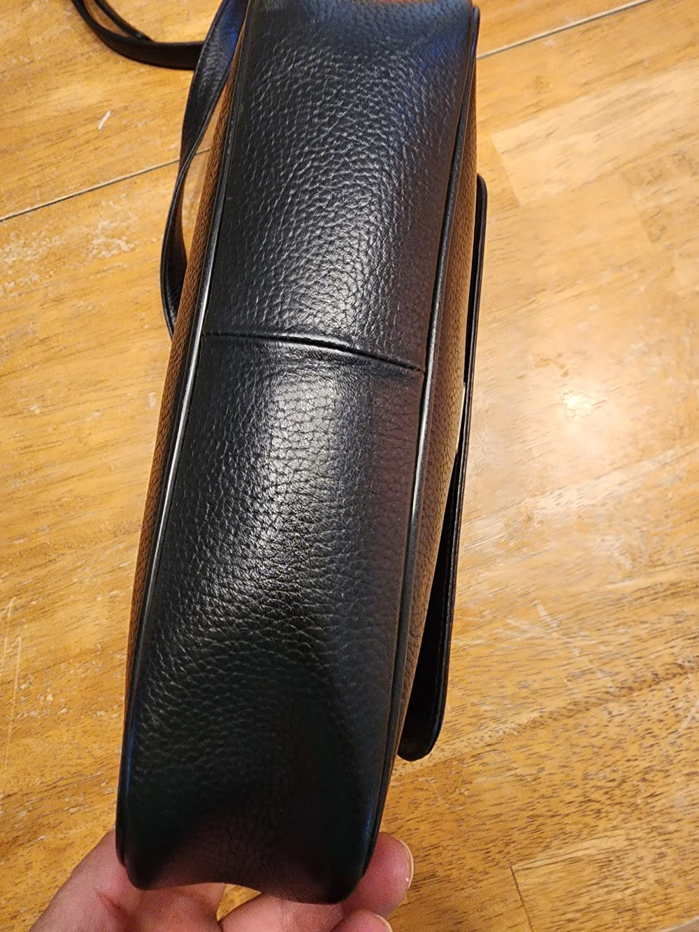 vintage MCM black pebbled leather studded crossbody bag featuring a front plaque
